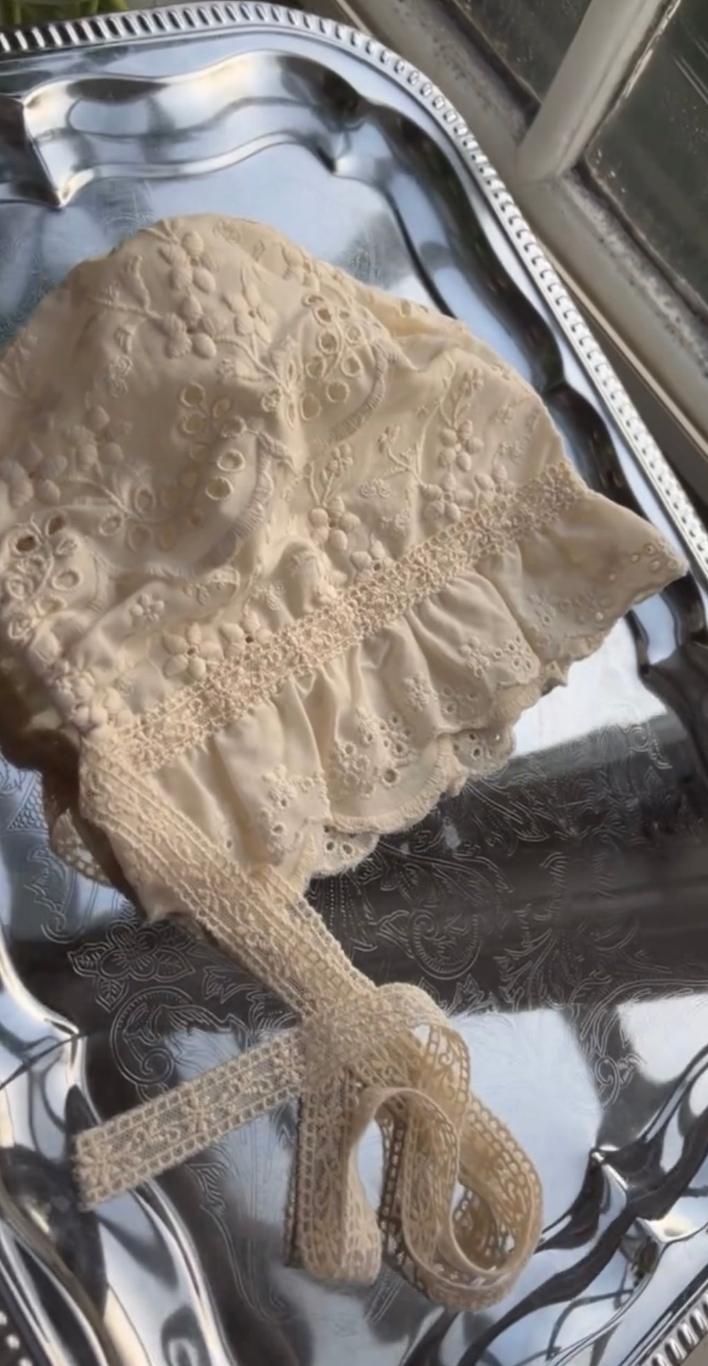 Elizabeth baby romper with a baby bonnet.