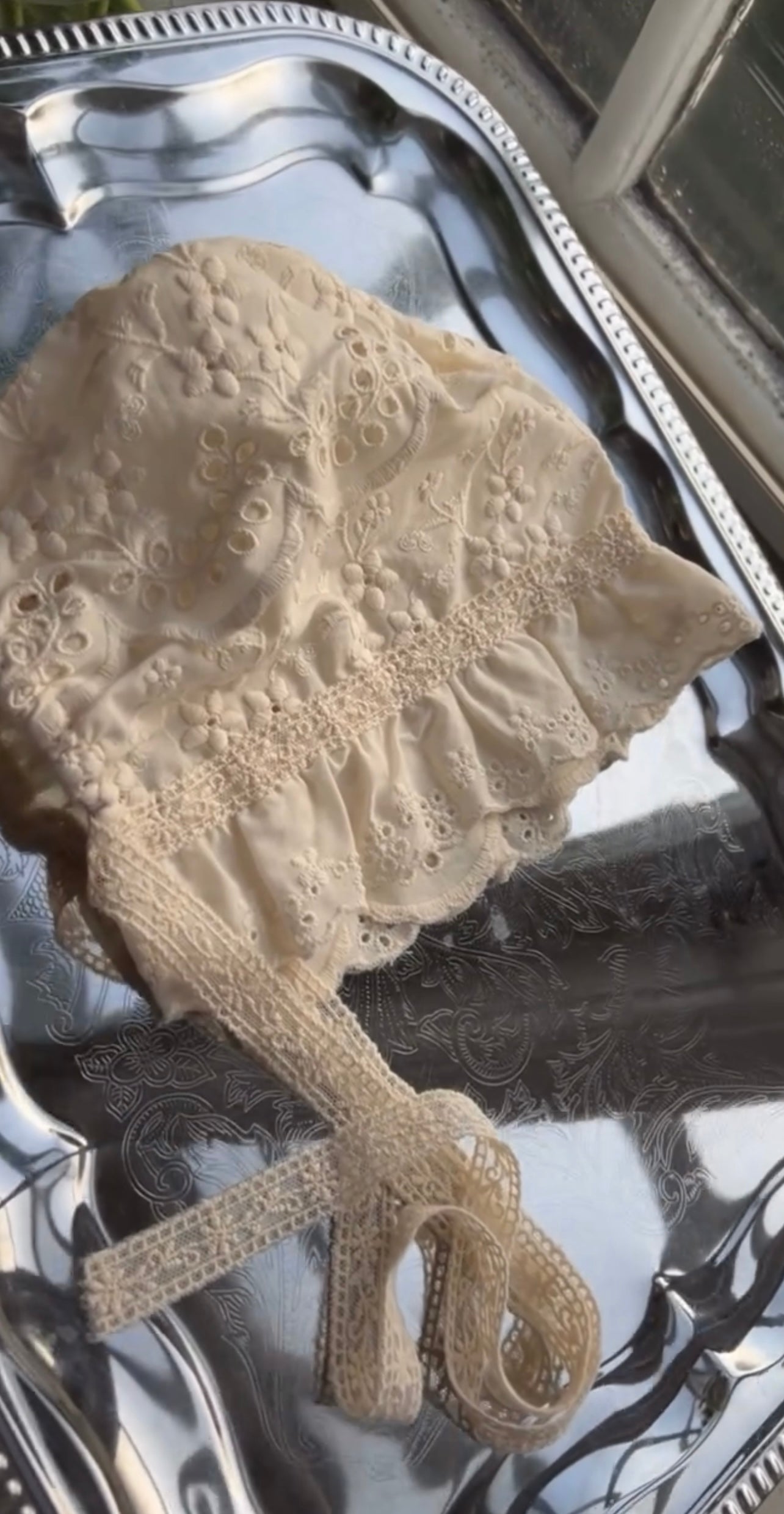 Elizabeth baby romper with a baby bonnet.