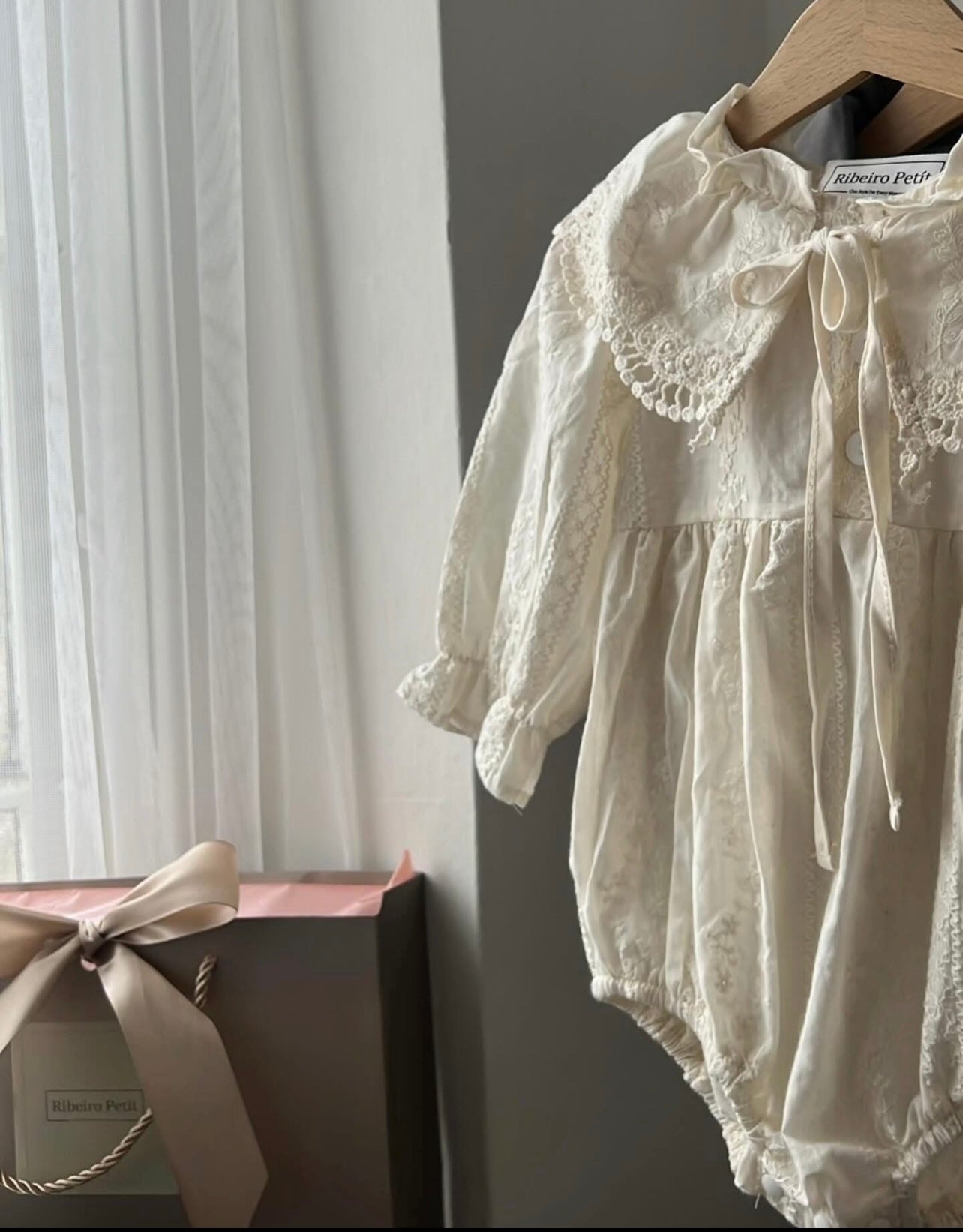 Elizabeth baby romper with a baby bonnet.