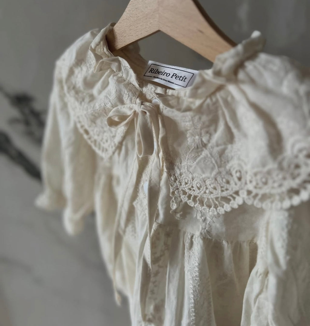 Elizabeth baby romper with a baby bonnet.